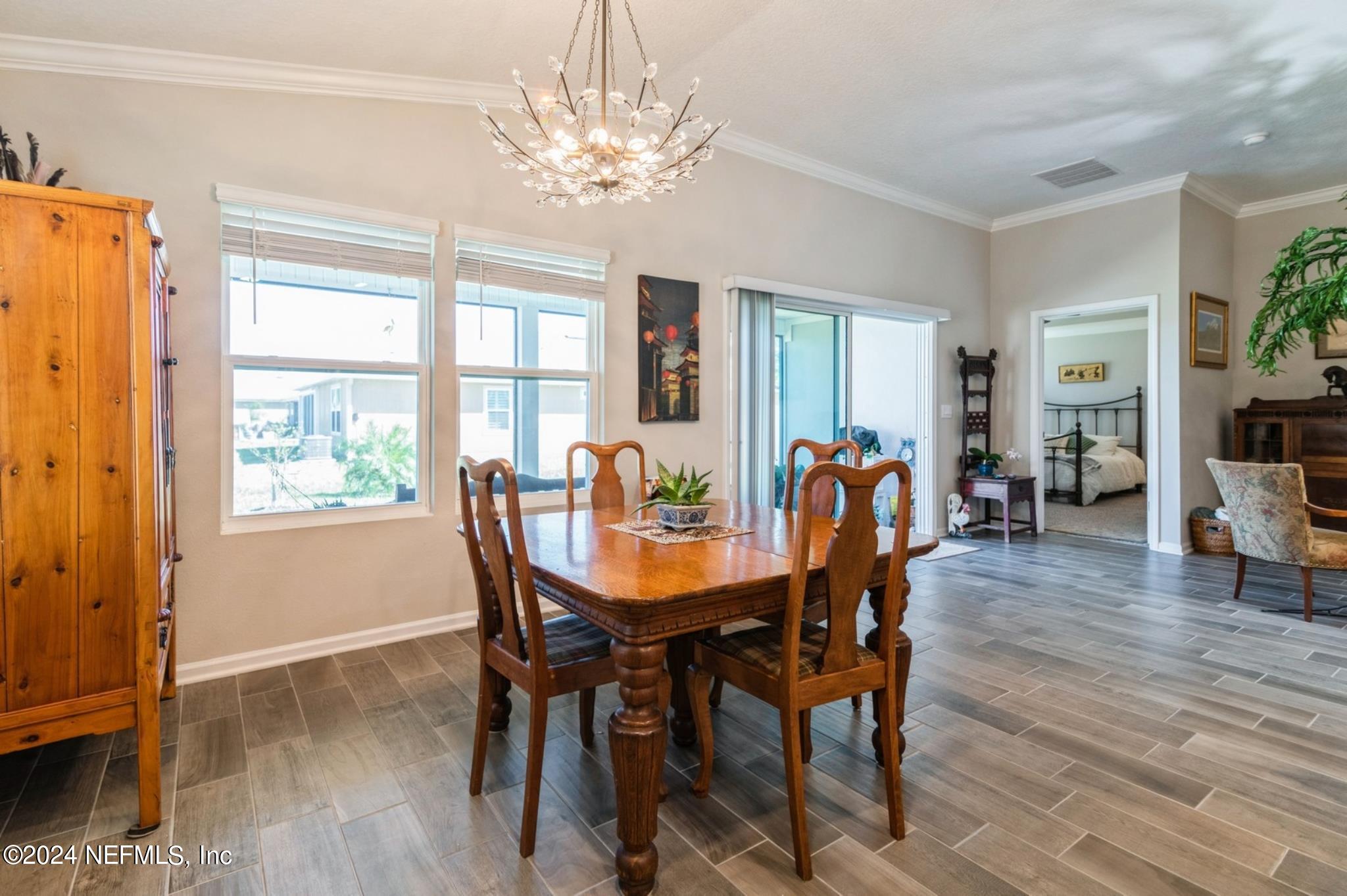 97 Spotted Owl Lane St. Augustine, FL 32095 - Photo 19 of 38 a view of a dining room with furniture window and wooden floor