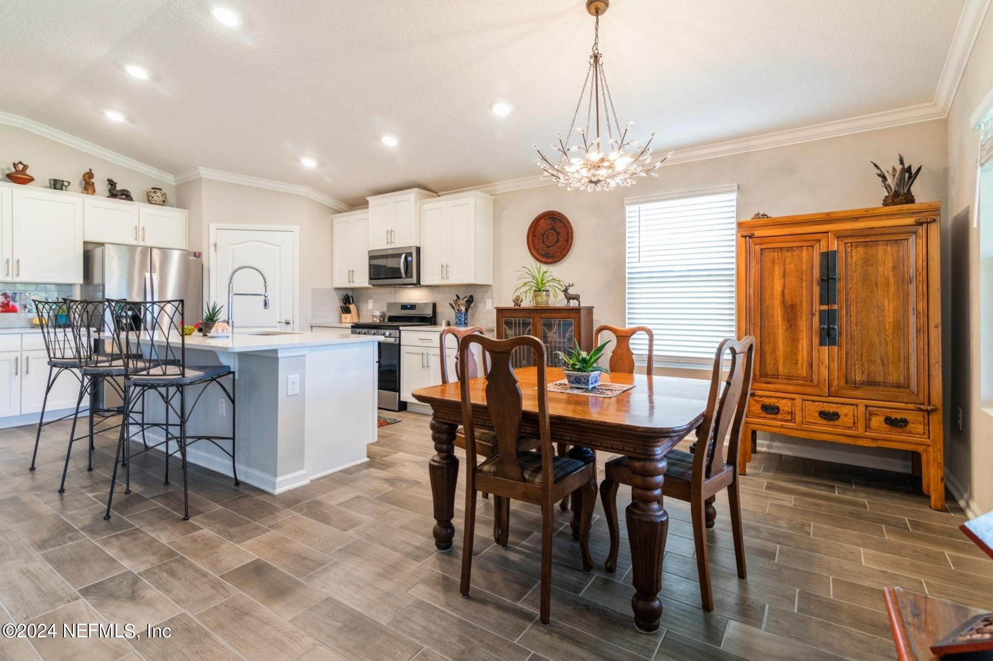 97 Spotted Owl Lane St. Augustine, FL 32095 - Photo 21 of 38 a view of a dining room with furniture and a chandelier