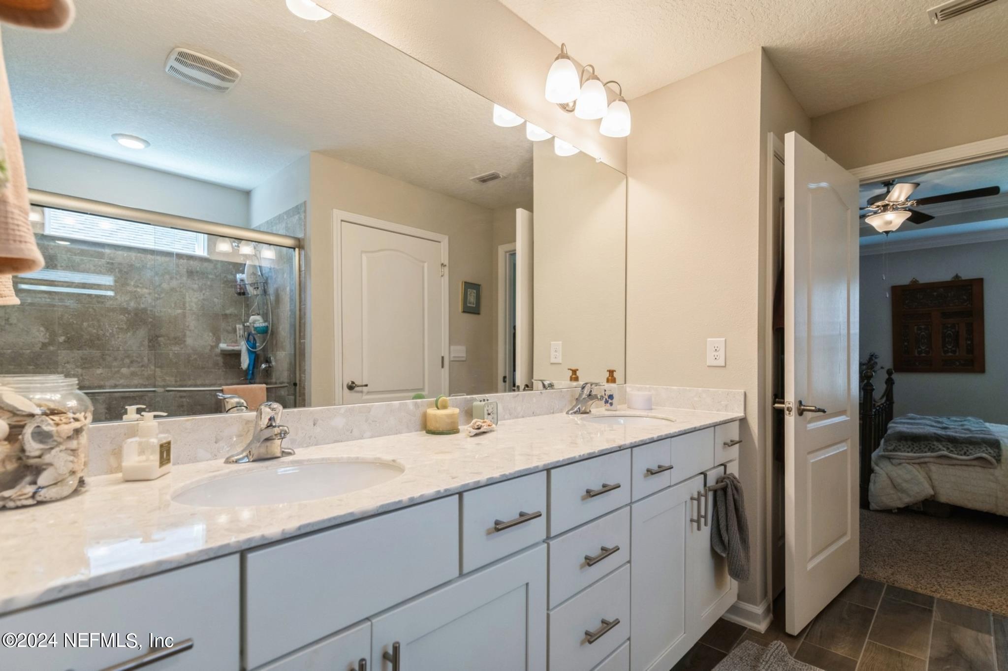 97 Spotted Owl Lane St. Augustine, FL 32095 - Photo 31 of 38 a en suite bathroom with a sink double vanity and a mirror