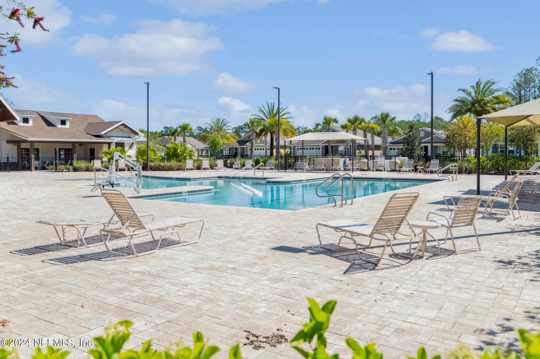 97 Spotted Owl Lane St. Augustine, FL 32095 - Photo 37 of 38 a view of a swimming pool with a lounge chairs