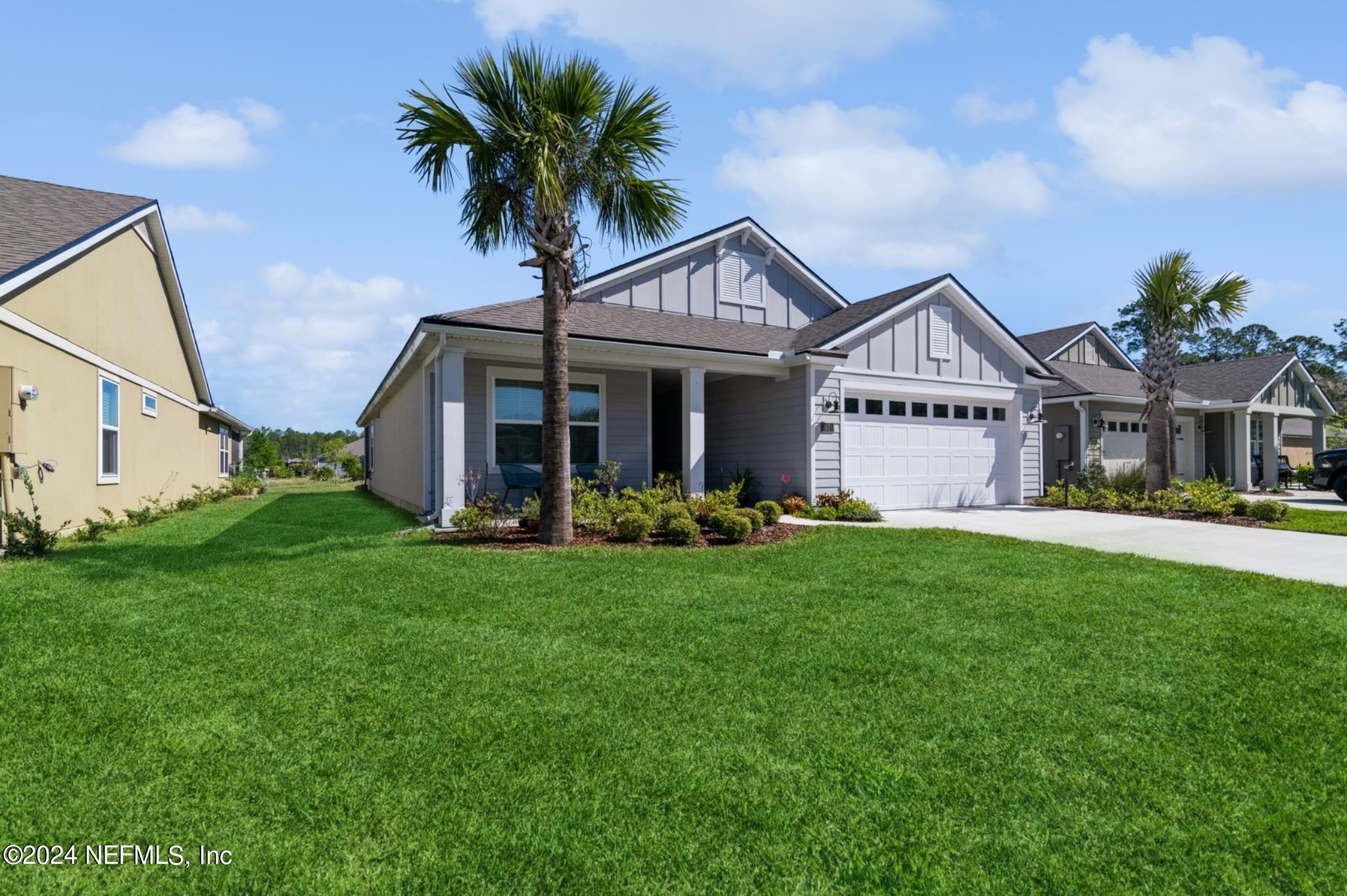 97 Spotted Owl Lane St. Augustine, FL 32095 - Photo 6 of 38 a front view of a house with a garden