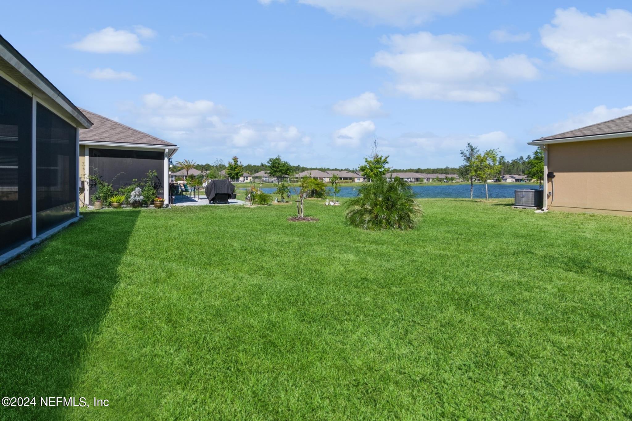 97 Spotted Owl Lane St. Augustine, FL 32095 - Photo 9 of 38 a view of a garden with a building in the background