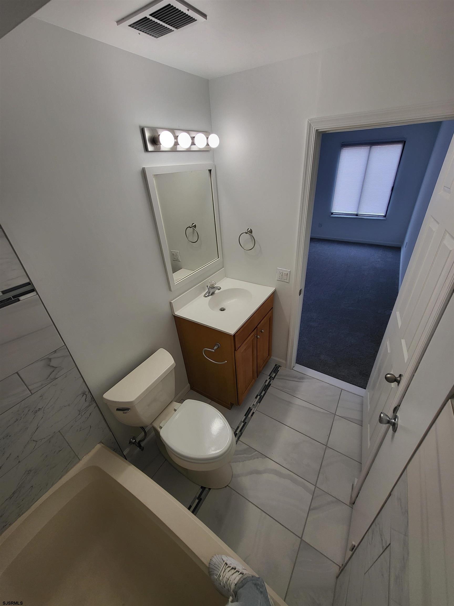 151 Fair Haven Hill Court, Unit 151 Galloway Township, NJ 08205 - Photo 15 of 21 a bathroom with a toilet sink and mirror