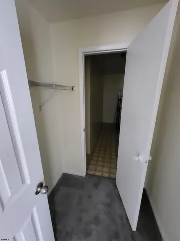 a picture of a bathroom with a white wall and a white kitchen with a sink