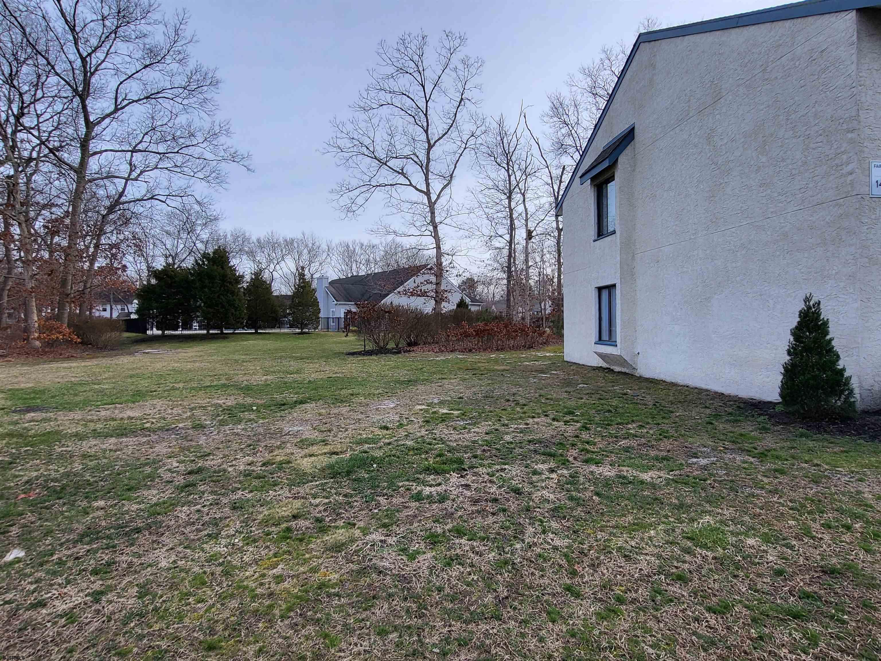 151 Fair Haven Hill Court, Unit 151 Galloway Township, NJ 08205 - Photo 17 of 21 a view of a backyard with large trees