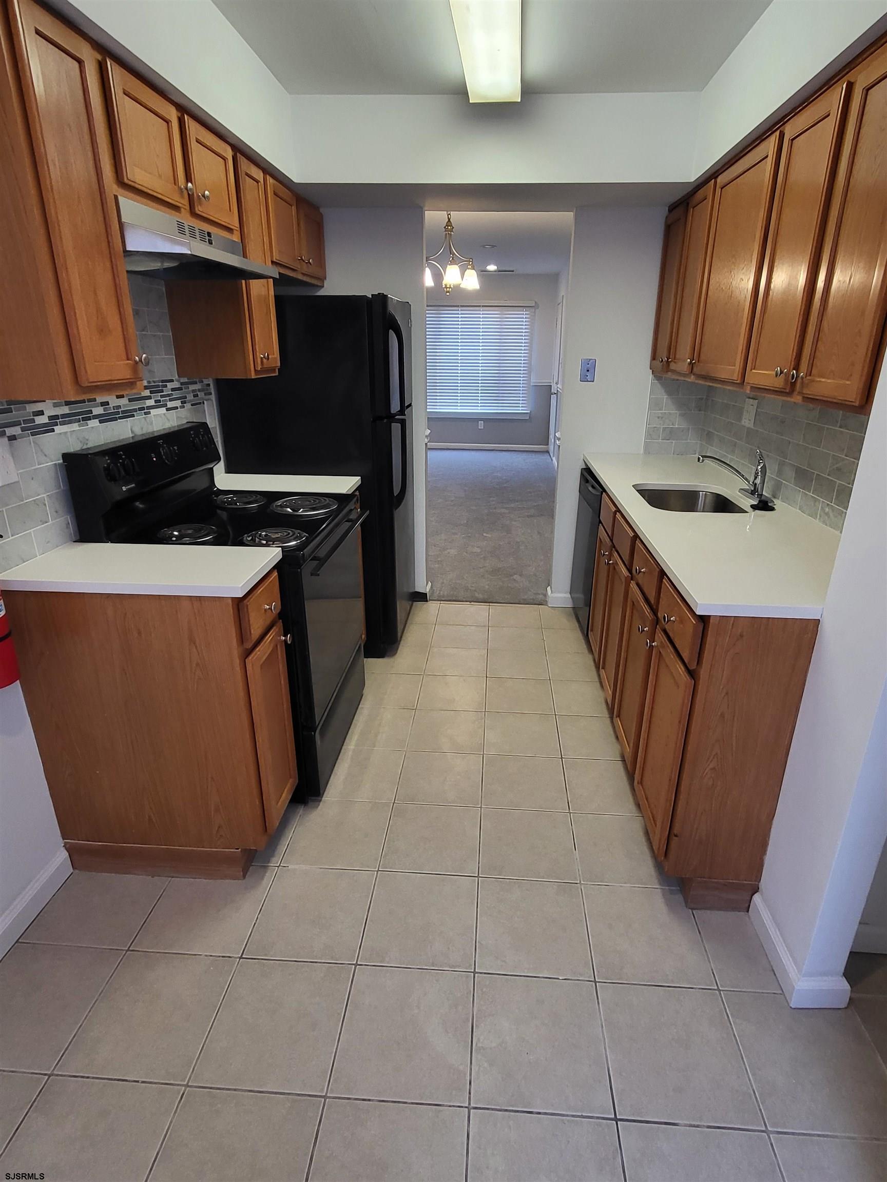 151 Fair Haven Hill Court, Unit 151 Galloway Township, NJ 08205 - Photo 2 of 21 a kitchen with stainless steel appliances granite countertop a stove a sink and a refrigerator