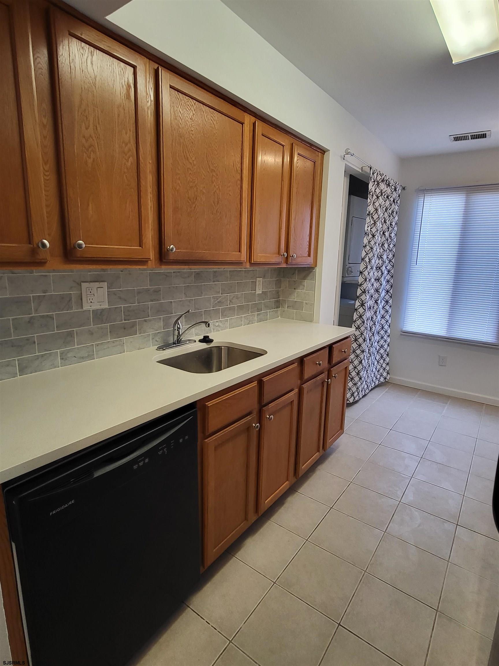 151 Fair Haven Hill Court, Unit 151 Galloway Township, NJ 08205 - Photo 3 of 21 a kitchen with a sink window and cabinets