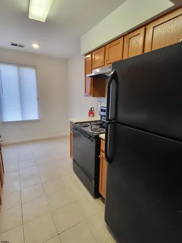 a kitchen with a refrigerator and a sink