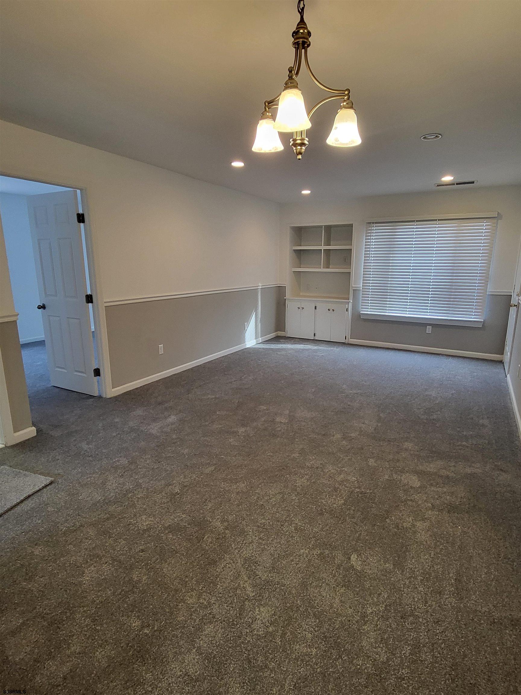 151 Fair Haven Hill Court, Unit 151 Galloway Township, NJ 08205 - Photo 5 of 21 a view of an empty room with window cabinet and fireplace