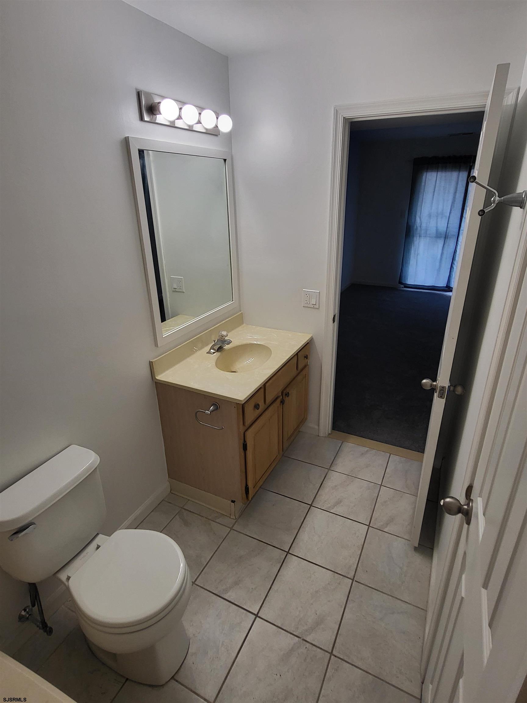 151 Fair Haven Hill Court, Unit 151 Galloway Township, NJ 08205 - Photo 9 of 21 a bathroom with a toilet a sink and mirror