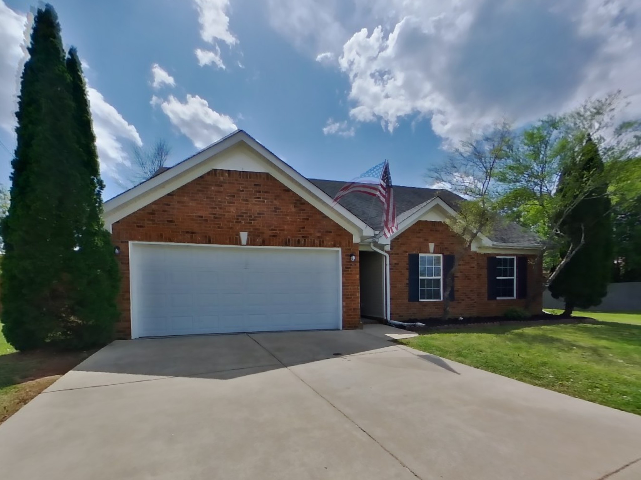 3504 Flora Drive Spring Hill, TN 37174 - Photo 1 of 18 a front view of a house with a yard and garage