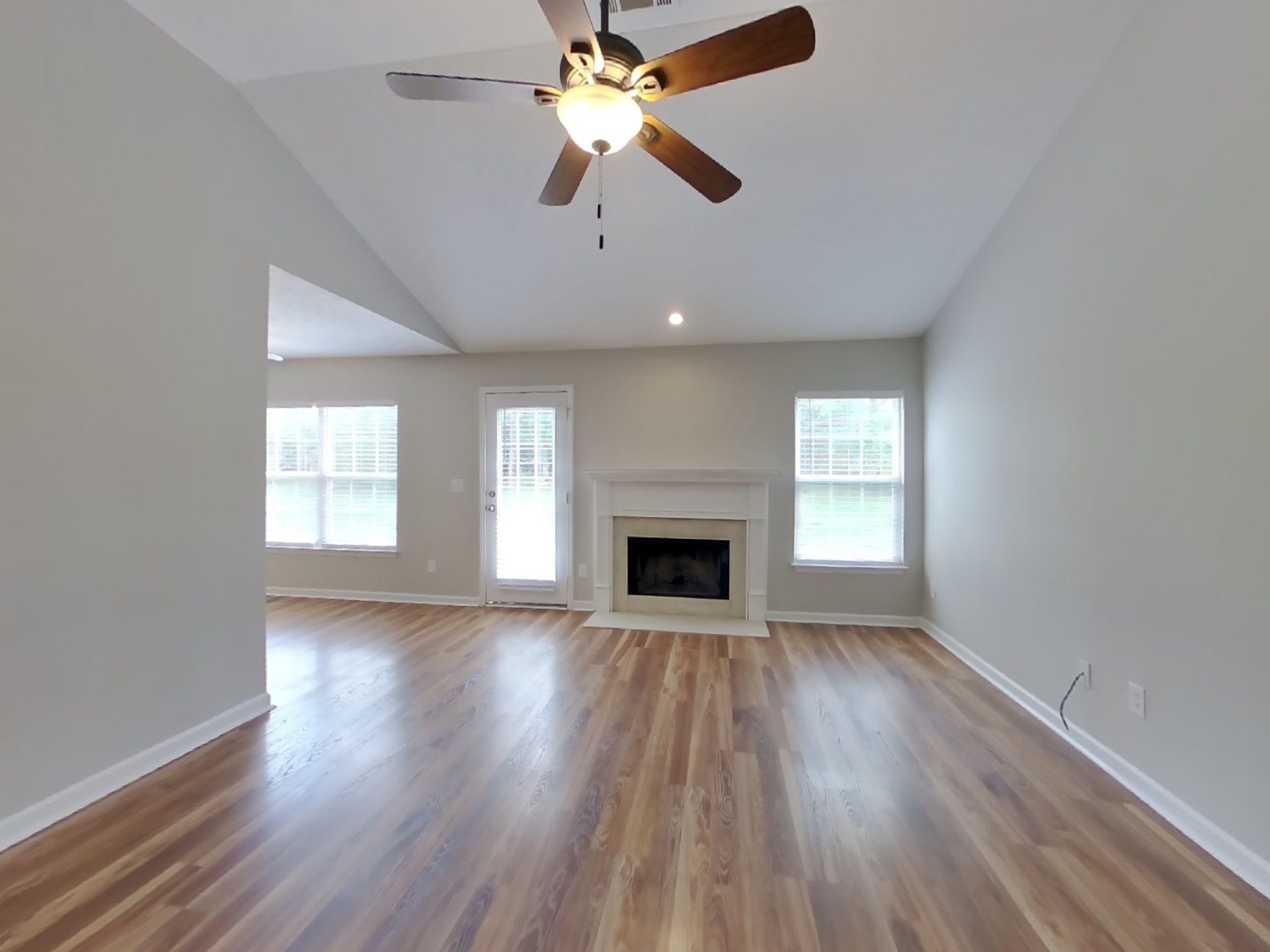 3504 Flora Drive Spring Hill, TN 37174 - Photo 3 of 18 wooden floor fireplace and windows in an empty room
