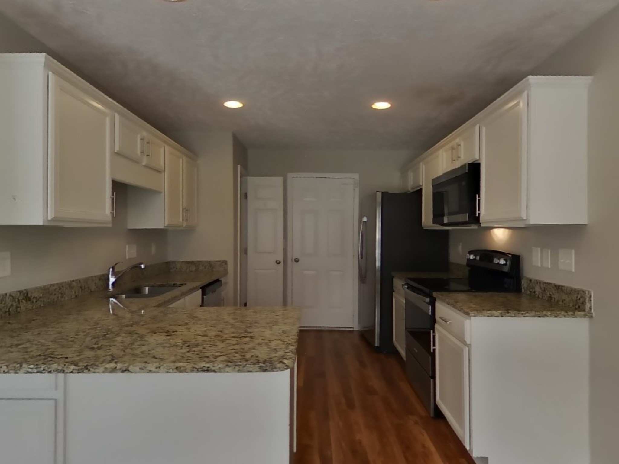 3504 Flora Drive Spring Hill, TN 37174 - Photo 5 of 18 a kitchen with stainless steel appliances granite countertop a sink stove and microwave