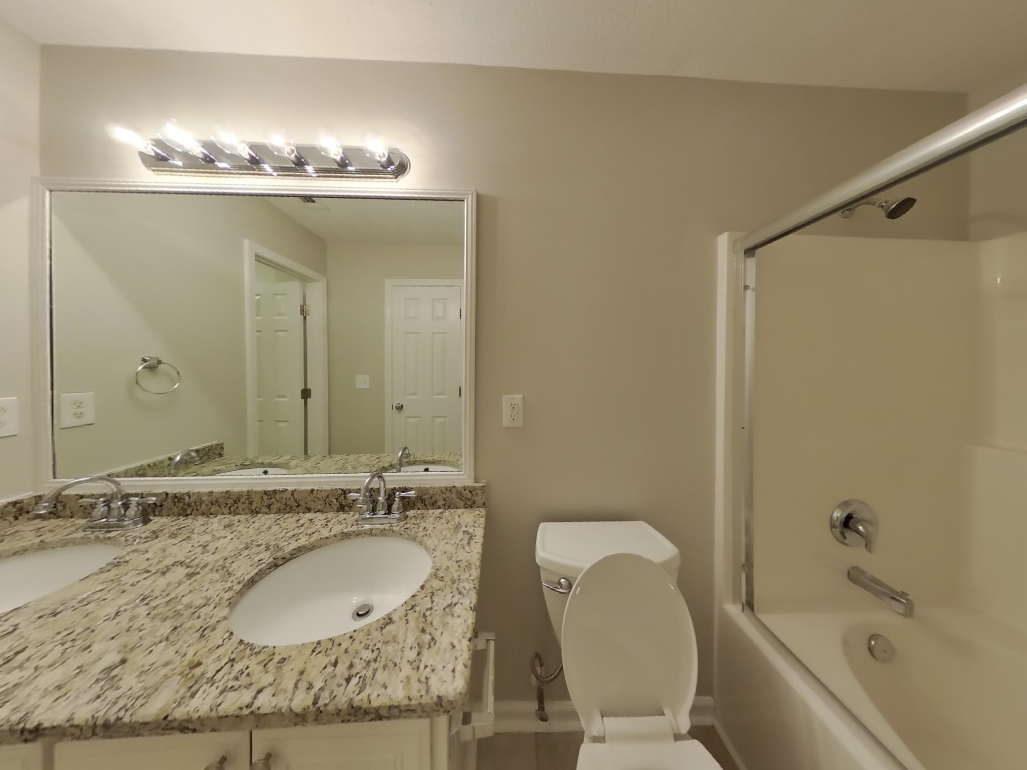 3504 Flora Drive Spring Hill, TN 37174 - Photo 10 of 18 a bathroom with a granite countertop sink a mirror and a bathtub