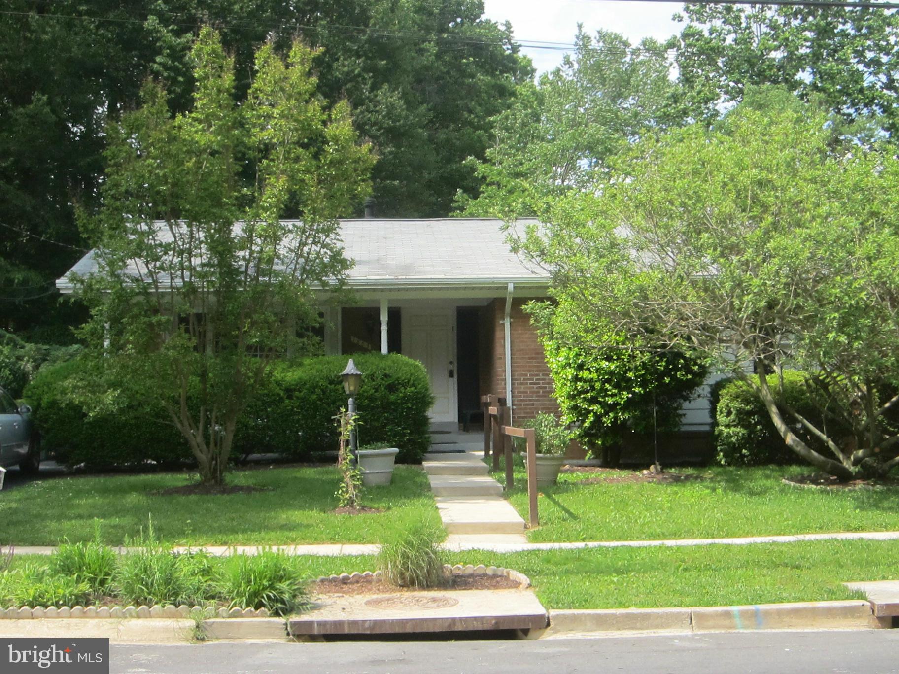 1803 Briggs Road Silver Spring, MD 20906 - Photo 2 of 19 a front view of a house with a yard
