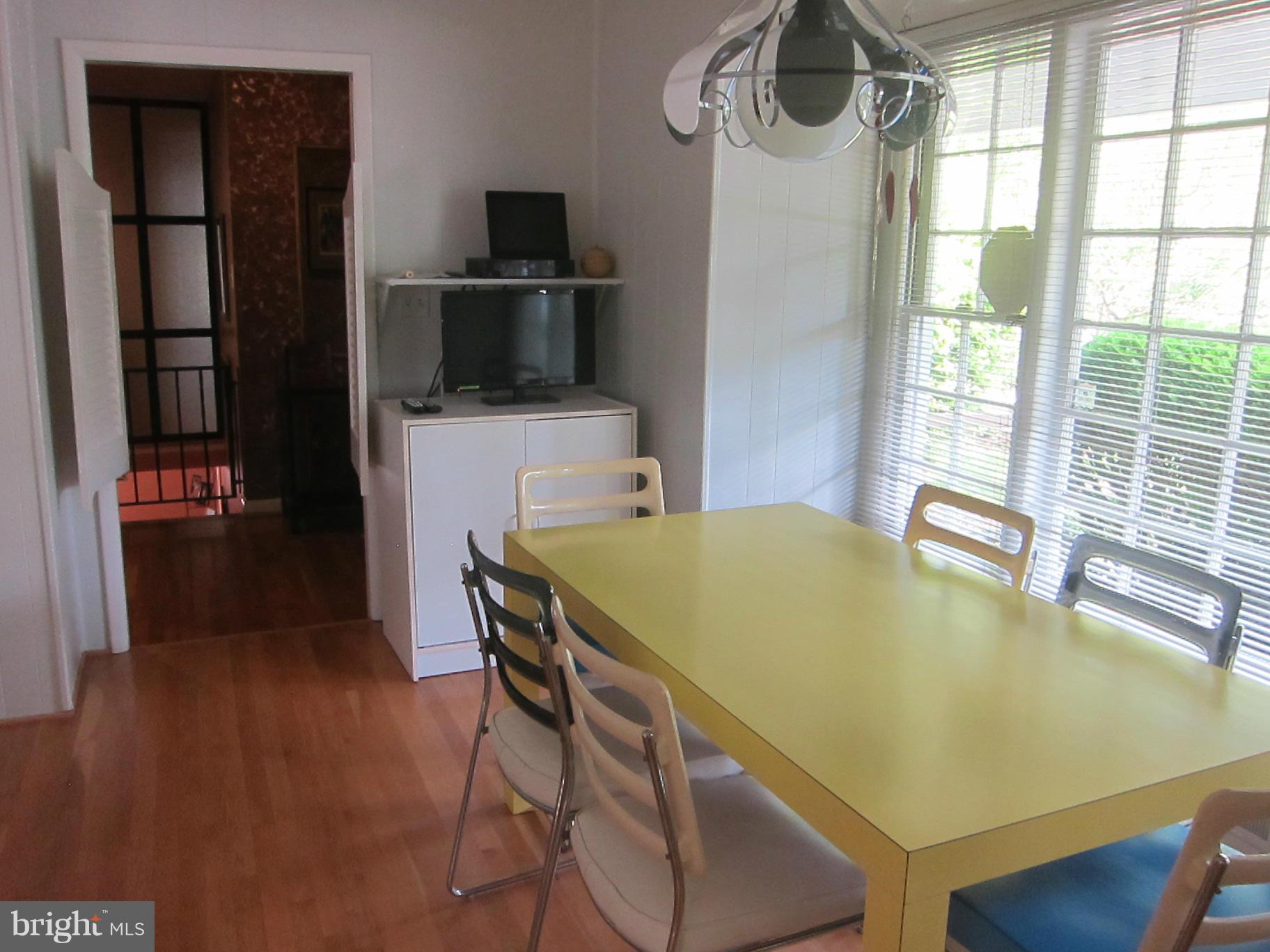 1803 Briggs Road Silver Spring, MD 20906 - Photo 15 of 19 a dining table with chairs and wooden floor