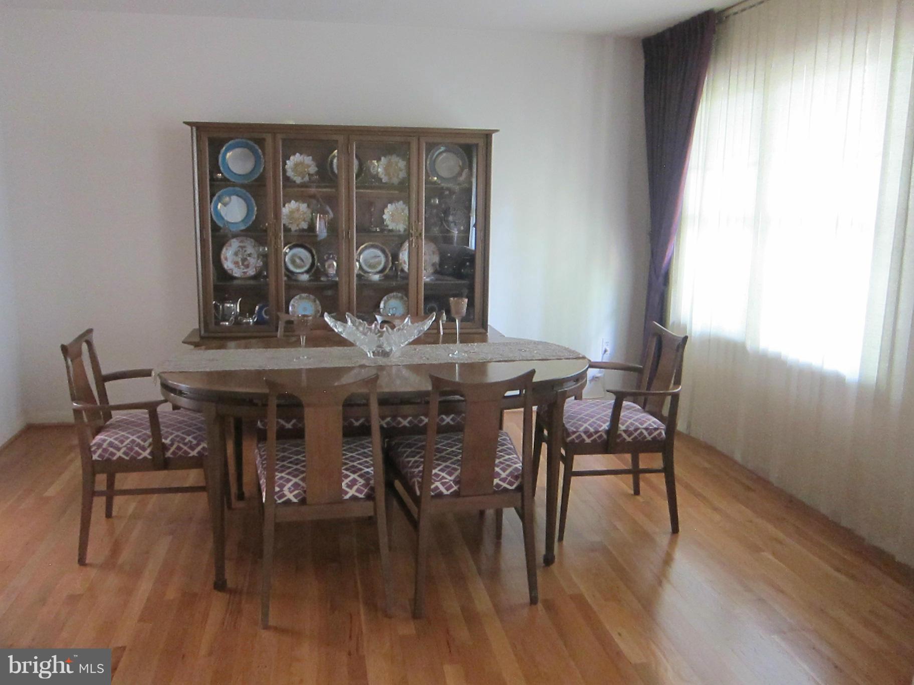 1803 Briggs Road Silver Spring, MD 20906 - Photo 8 of 19 a view of a dining room with furniture and wooden floor