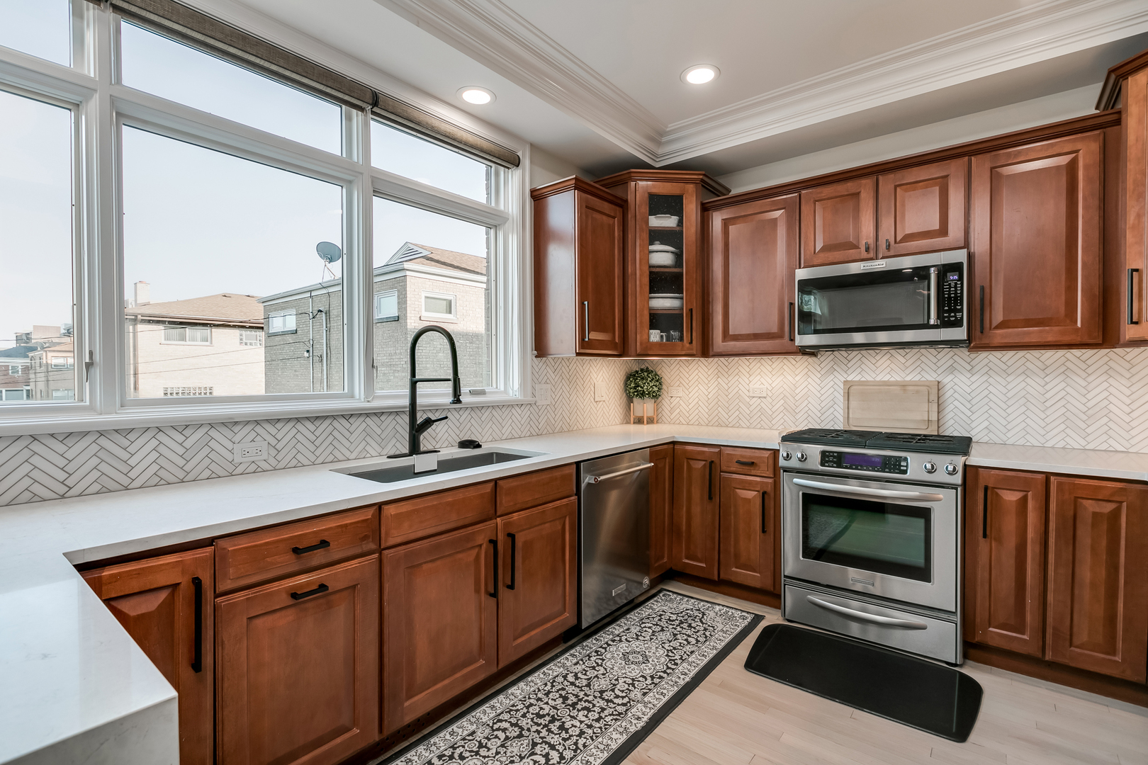 463 Summit Avenue, Unit D Park Ridge, IL 60068 - Photo 14 of 30 a kitchen with stainless steel appliances granite countertop a stove sink and microwave