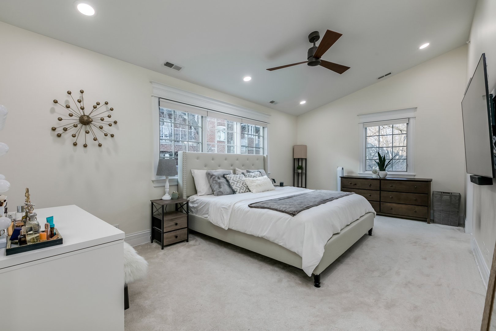 463 Summit Avenue, Unit D Park Ridge, IL 60068 - Photo 19 of 30 a spacious bedroom with a bed and a chandelier