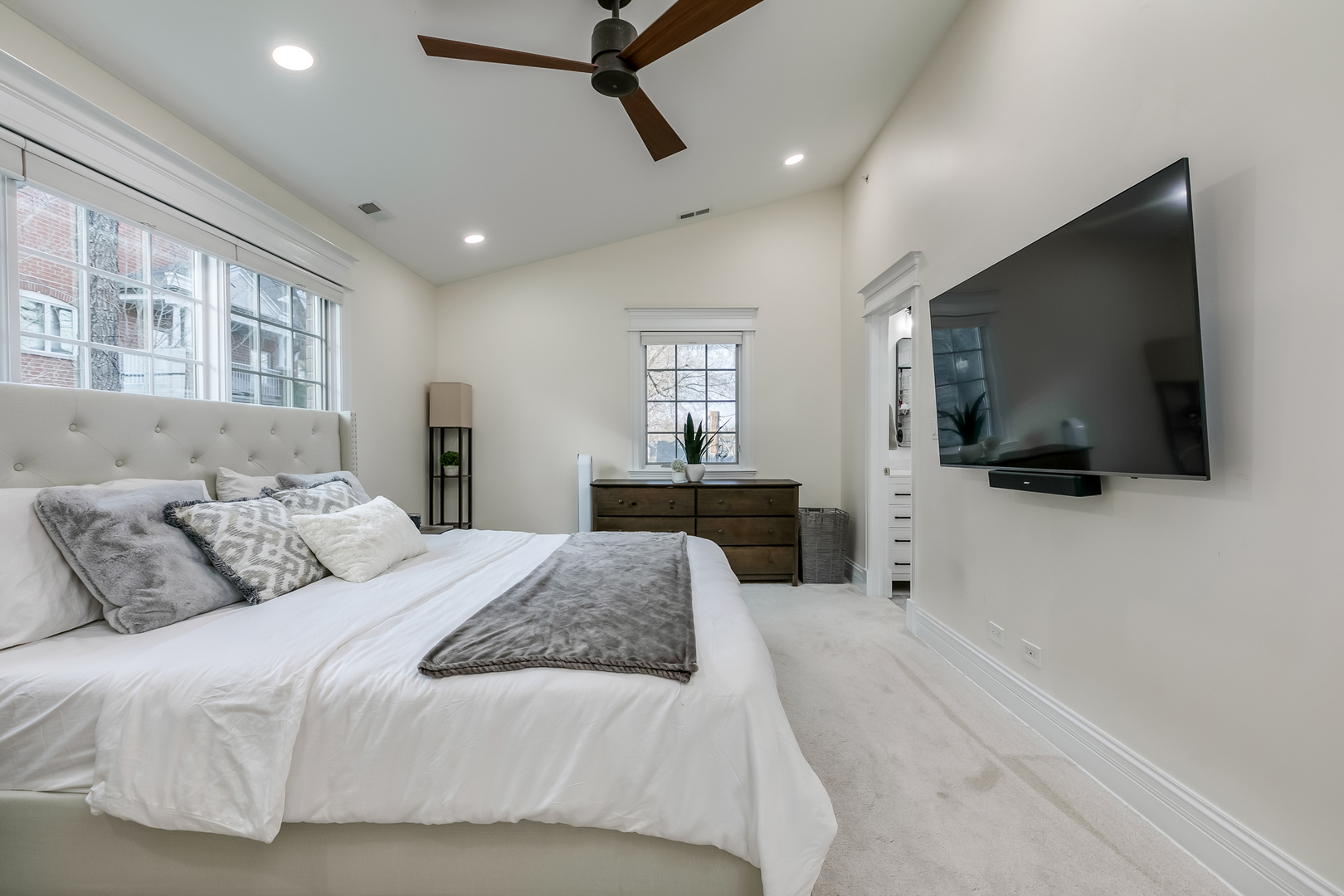 463 Summit Avenue, Unit D Park Ridge, IL 60068 - Photo 20 of 30 a bedroom with a large bed and a flat screen tv