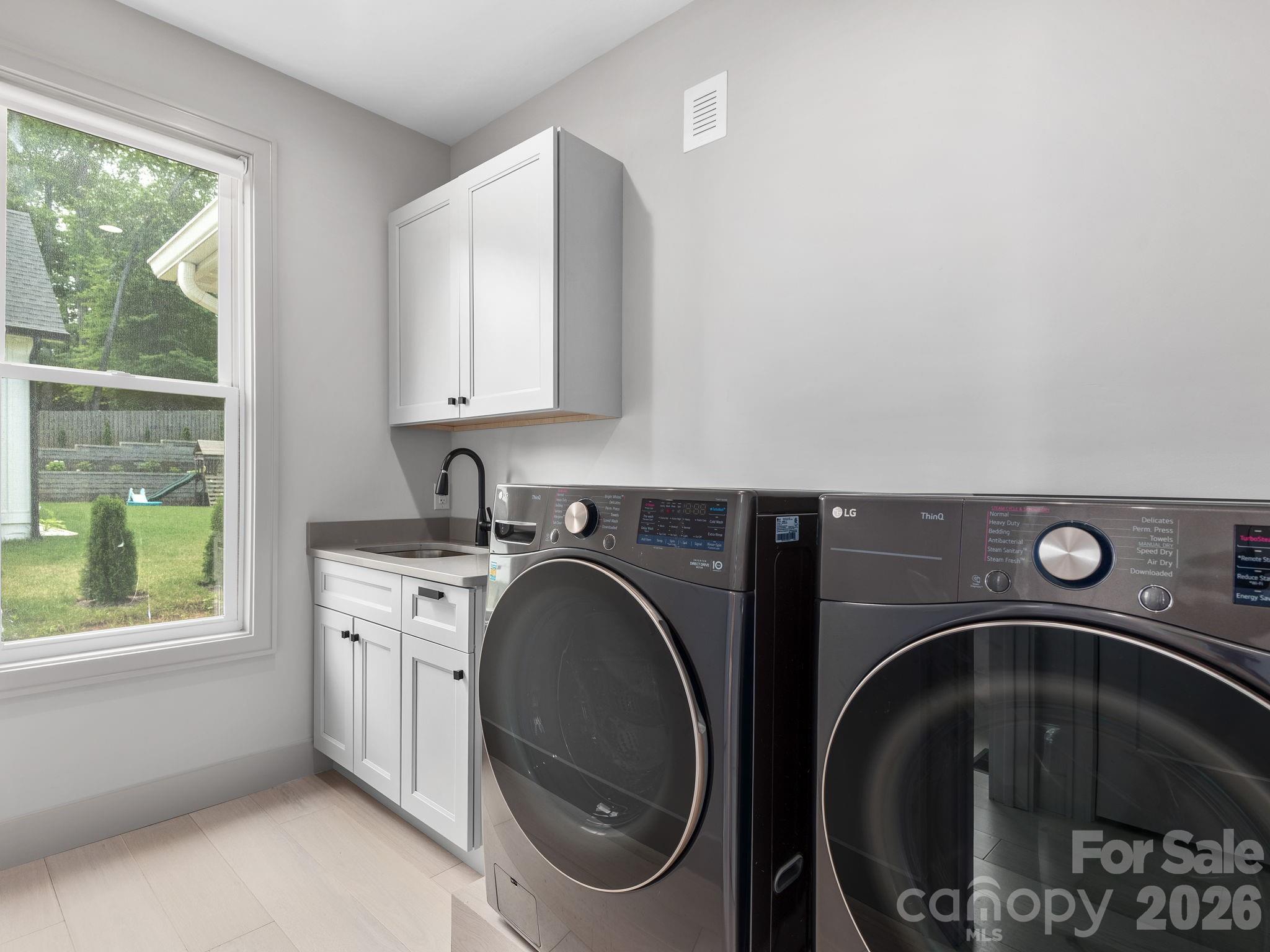 7 Copper Mill Court Candler, NC 28715 - Photo 12 of 32 a utility room with dryer and washer
