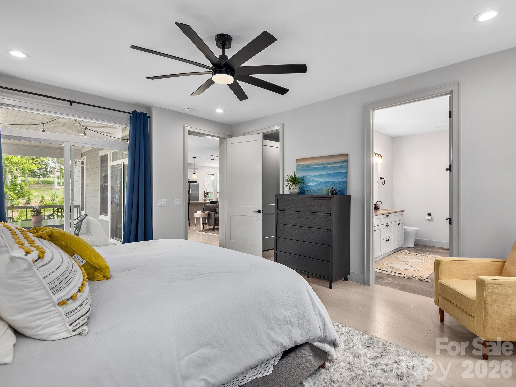 7 Copper Mill Court Candler, NC 28715 - Photo 14 of 32 a spacious bedroom with a bed and a chandelier