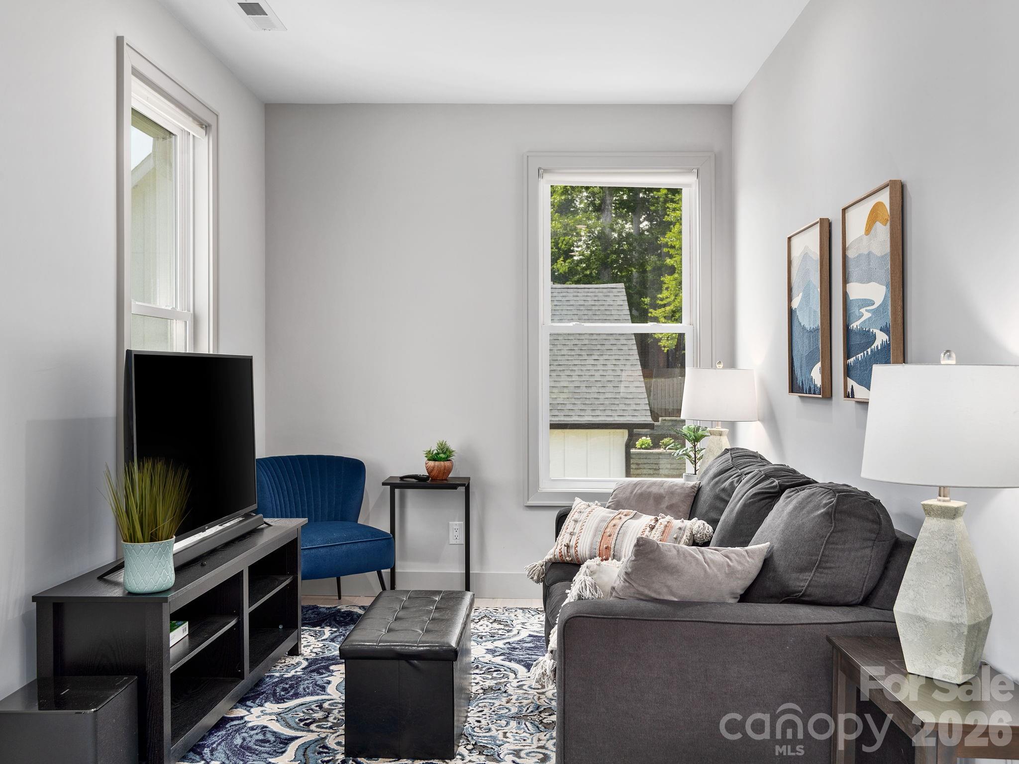 7 Copper Mill Court Candler, NC 28715 - Photo 19 of 32 a living room with furniture and a flat screen tv