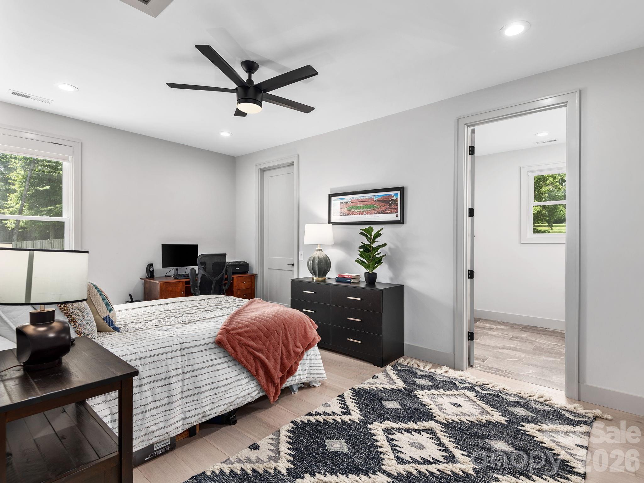 7 Copper Mill Court Candler, NC 28715 - Photo 22 of 32 a bedroom with a bed and wooden floor