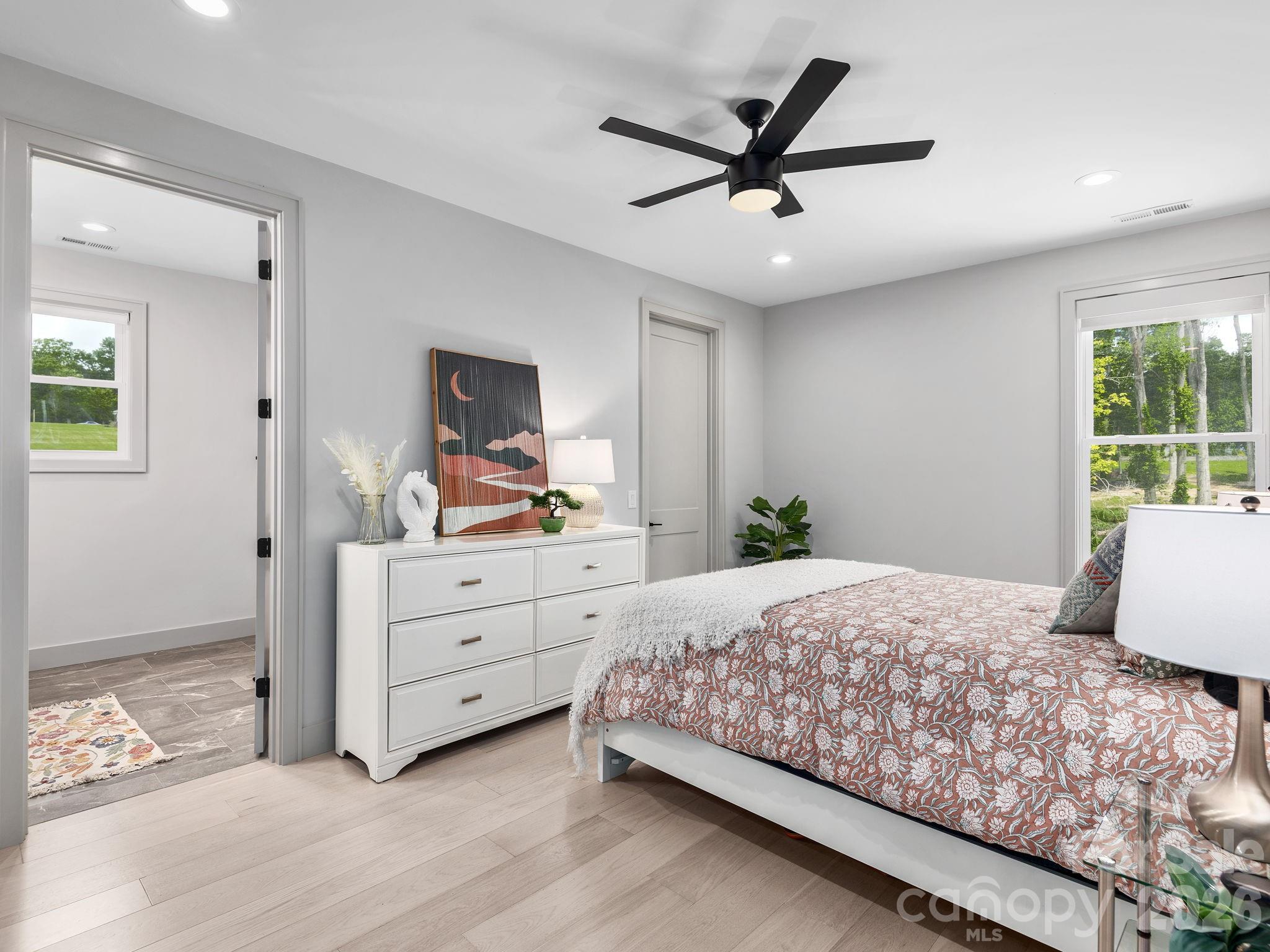 7 Copper Mill Court Candler, NC 28715 - Photo 25 of 32 a bedroom with a large bed and a window