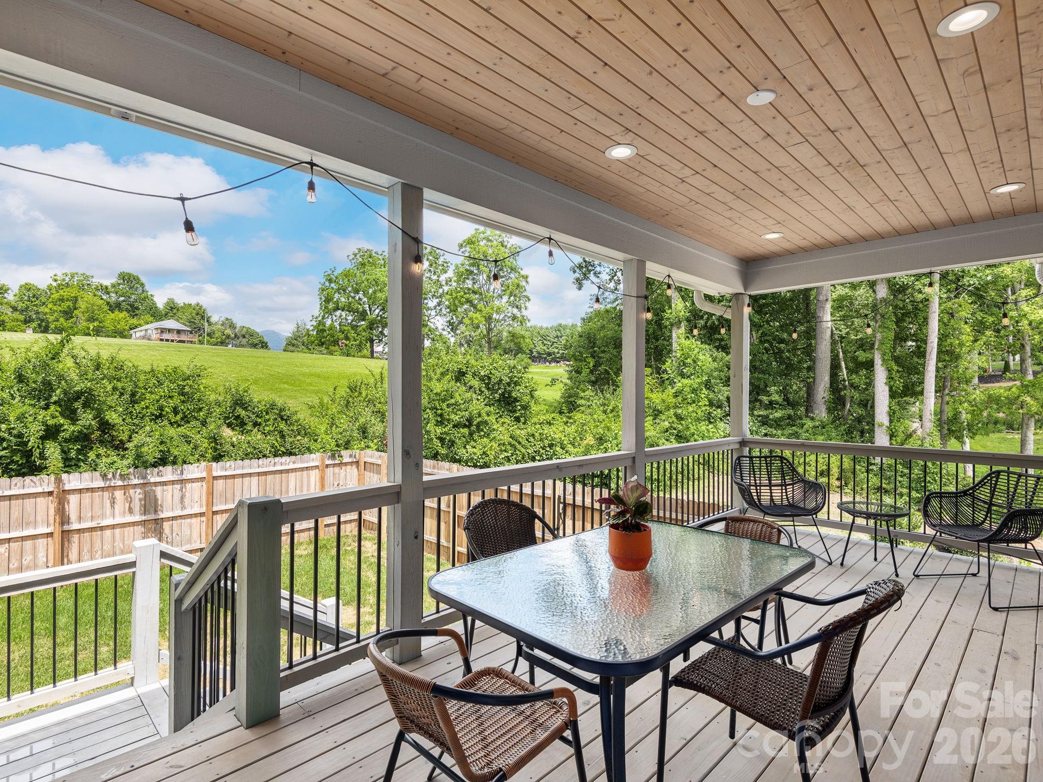 7 Copper Mill Court Candler, NC 28715 - Photo 28 of 32 a view of a patio with a table chairs and a table