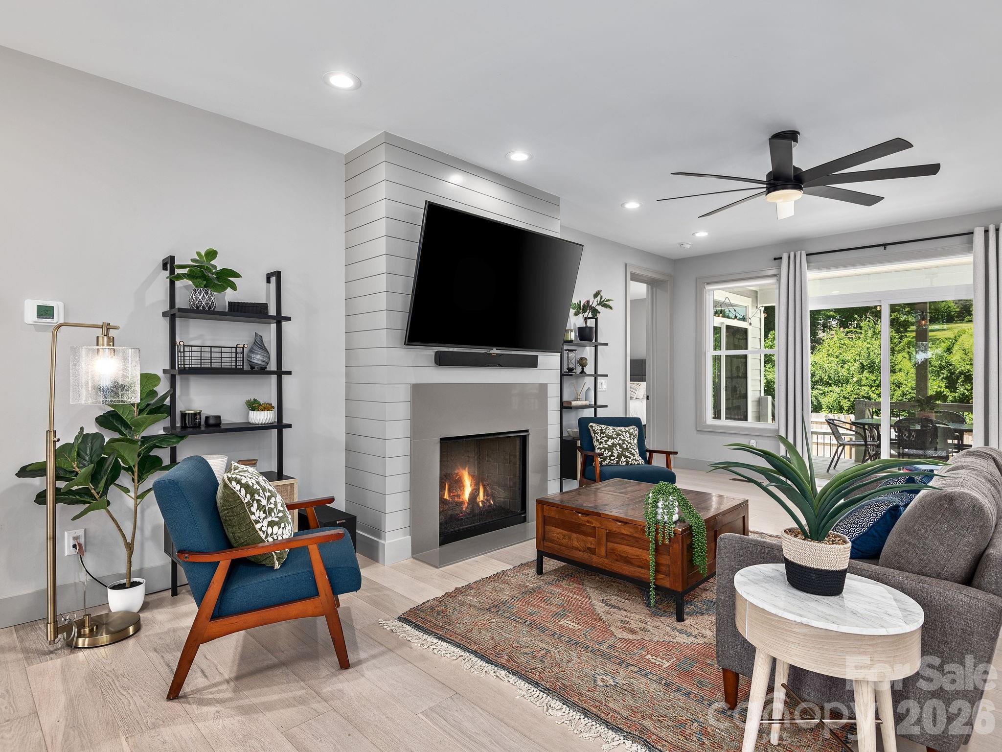 7 Copper Mill Court Candler, NC 28715 - Photo 5 of 32 a living room with furniture fireplace and a flat screen tv