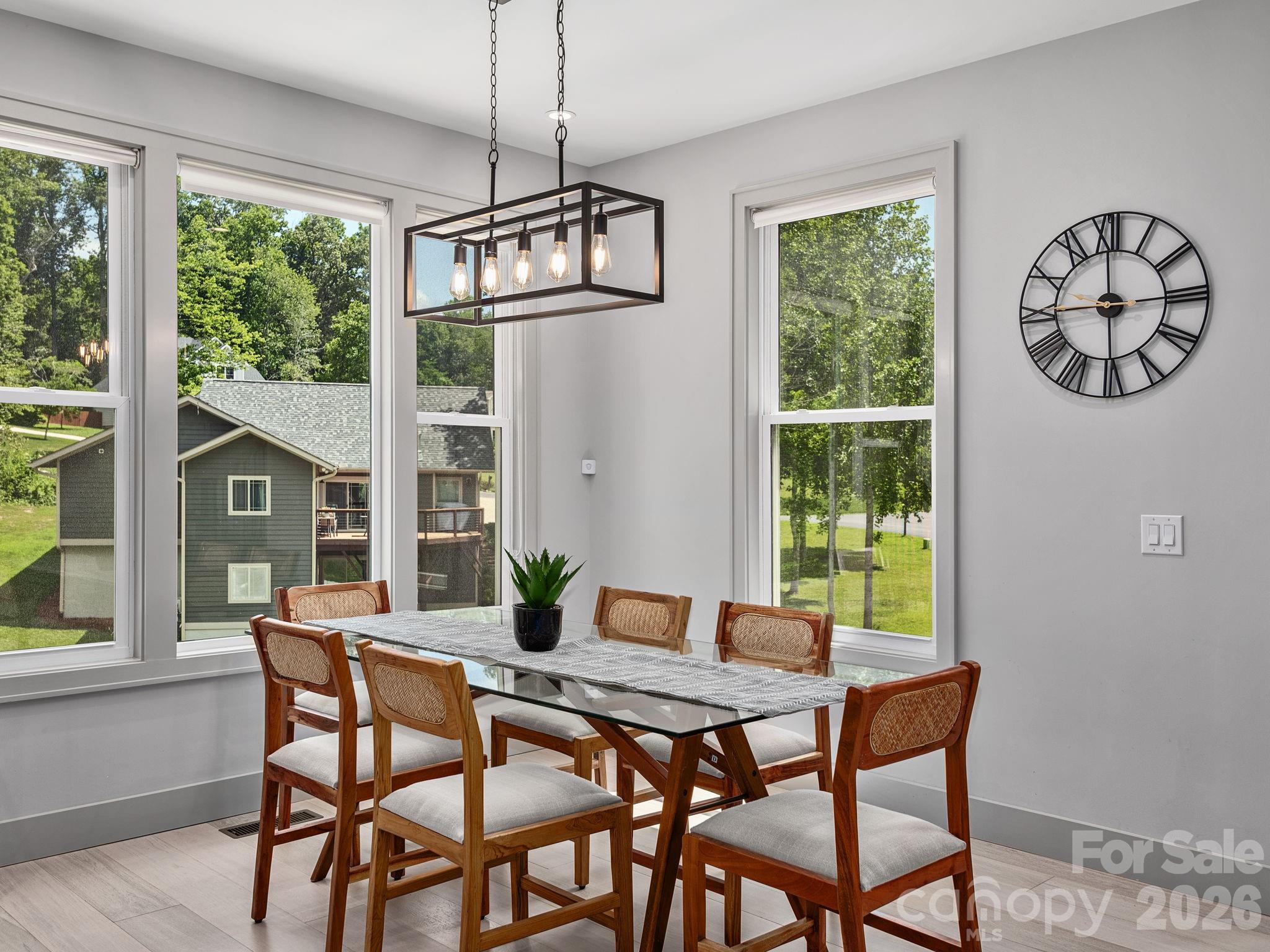 7 Copper Mill Court Candler, NC 28715 - Photo 8 of 32 a dining room with furniture a chandelier and wooden floor
