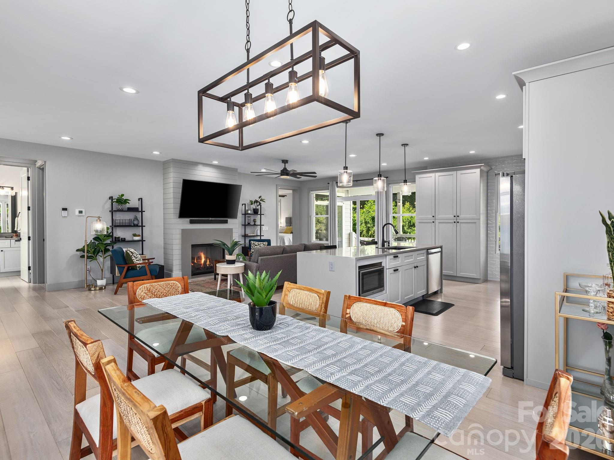 7 Copper Mill Court Candler, NC 28715 - Photo 9 of 32 a outdoor space with furniture a flat screen tv and a chandelier