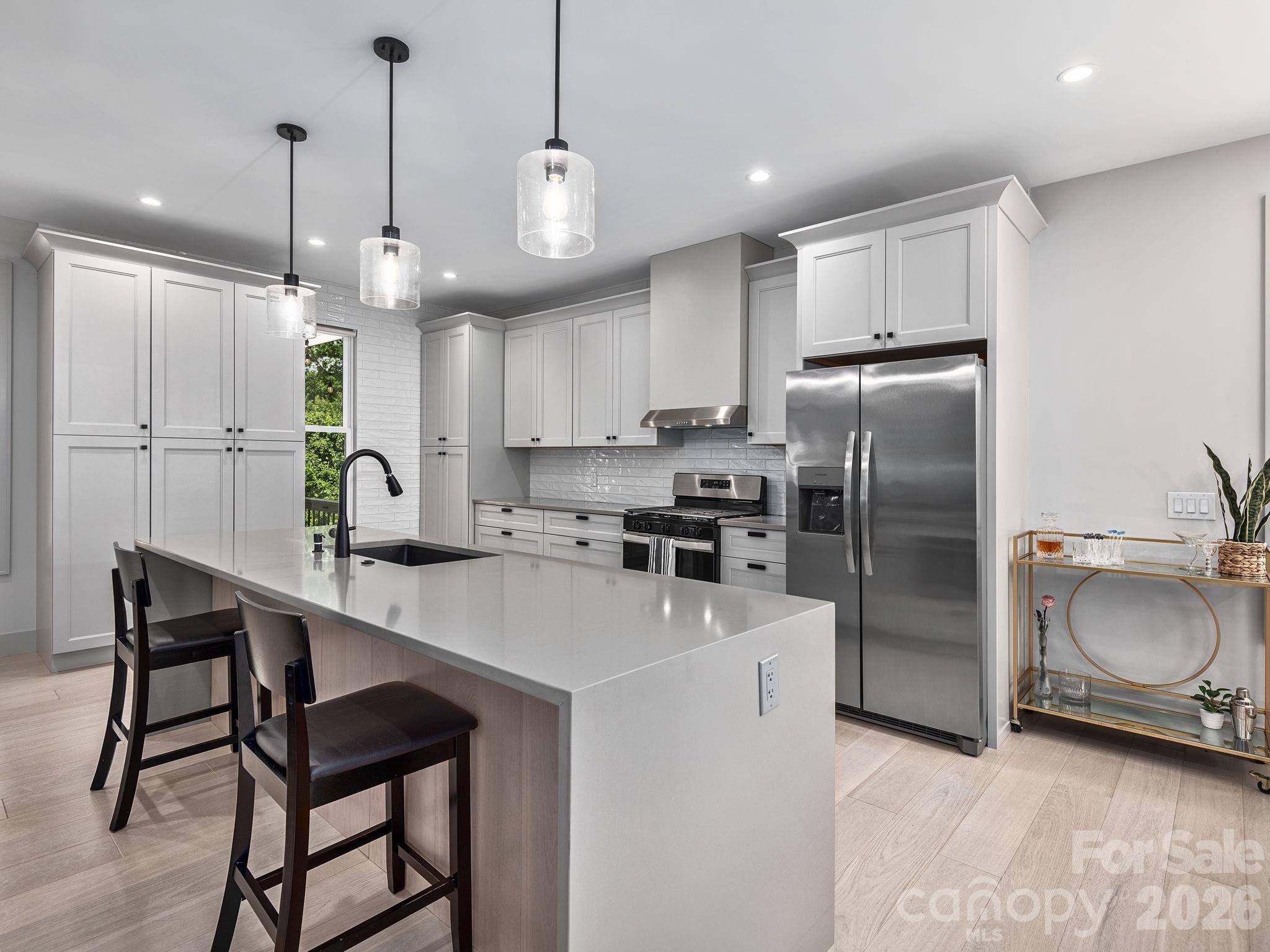 7 Copper Mill Court Candler, NC 28715 - Photo 10 of 32 a kitchen with stainless steel appliances granite countertop a sink a stove a refrigerator and island