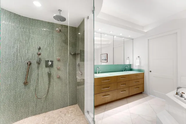 a bathroom with a sink a mirror and painting on the wall