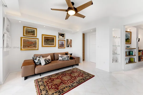 a very nice looking room with lots of white furniture