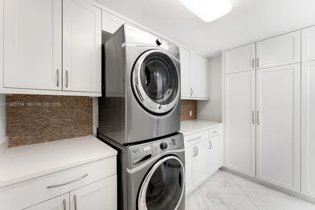 a dining room with furniture a chandelier and wooden floor