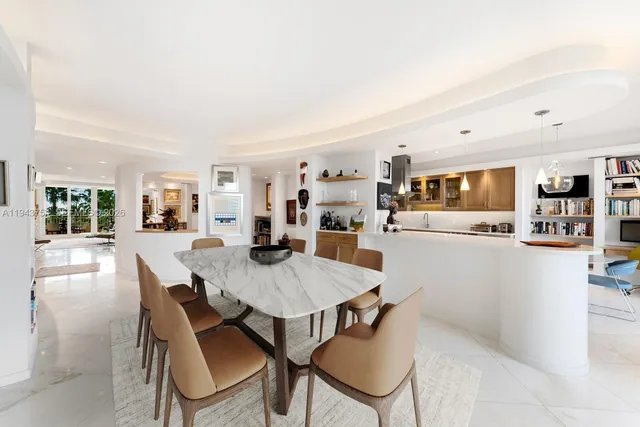 a large kitchen with kitchen island a large counter top space a sink stainless steel appliances and cabinets