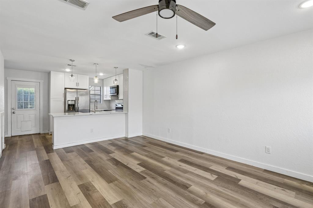 2400 Jupiter Road, Unit 6 Plano, TX 75074 - Photo 4 of 22 Open-concept living space with wood-finish flooring, a modern ceiling fan, and recessed lighting