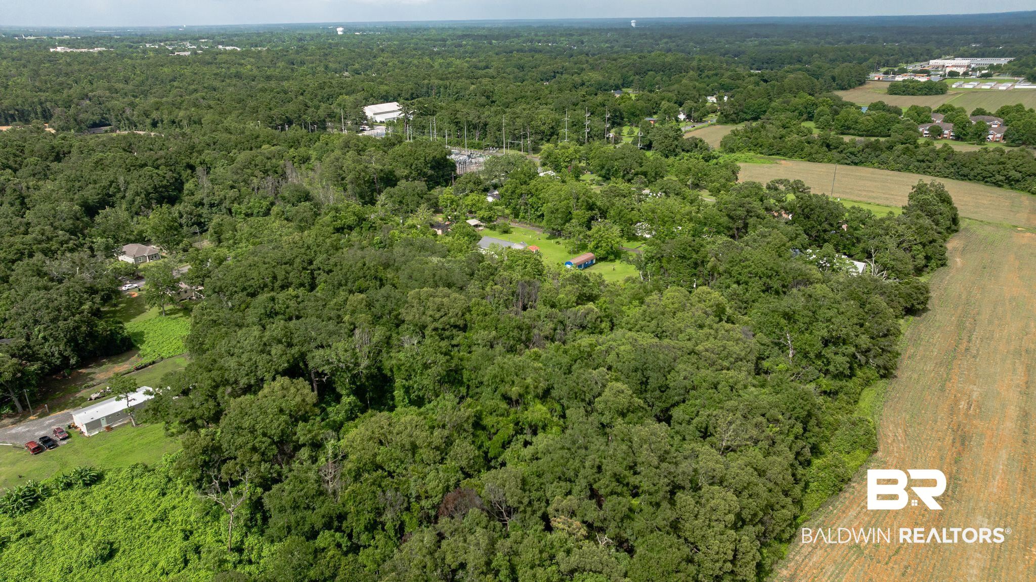 7360 Twin Beech Road Fairhope, AL 36532 - Photo 12 of 16 Aerial view of property's location with a heavily wooded area
