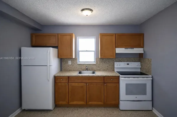 a utility room with cabinets washer and dryer
