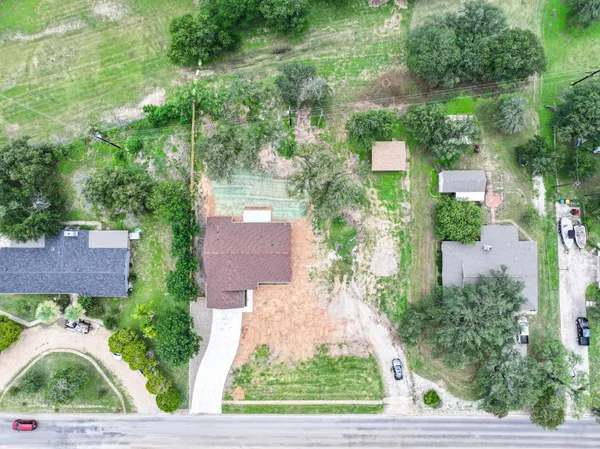 an aerial view of multiple houses with yard