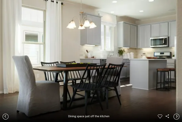 a dining room with furniture and window