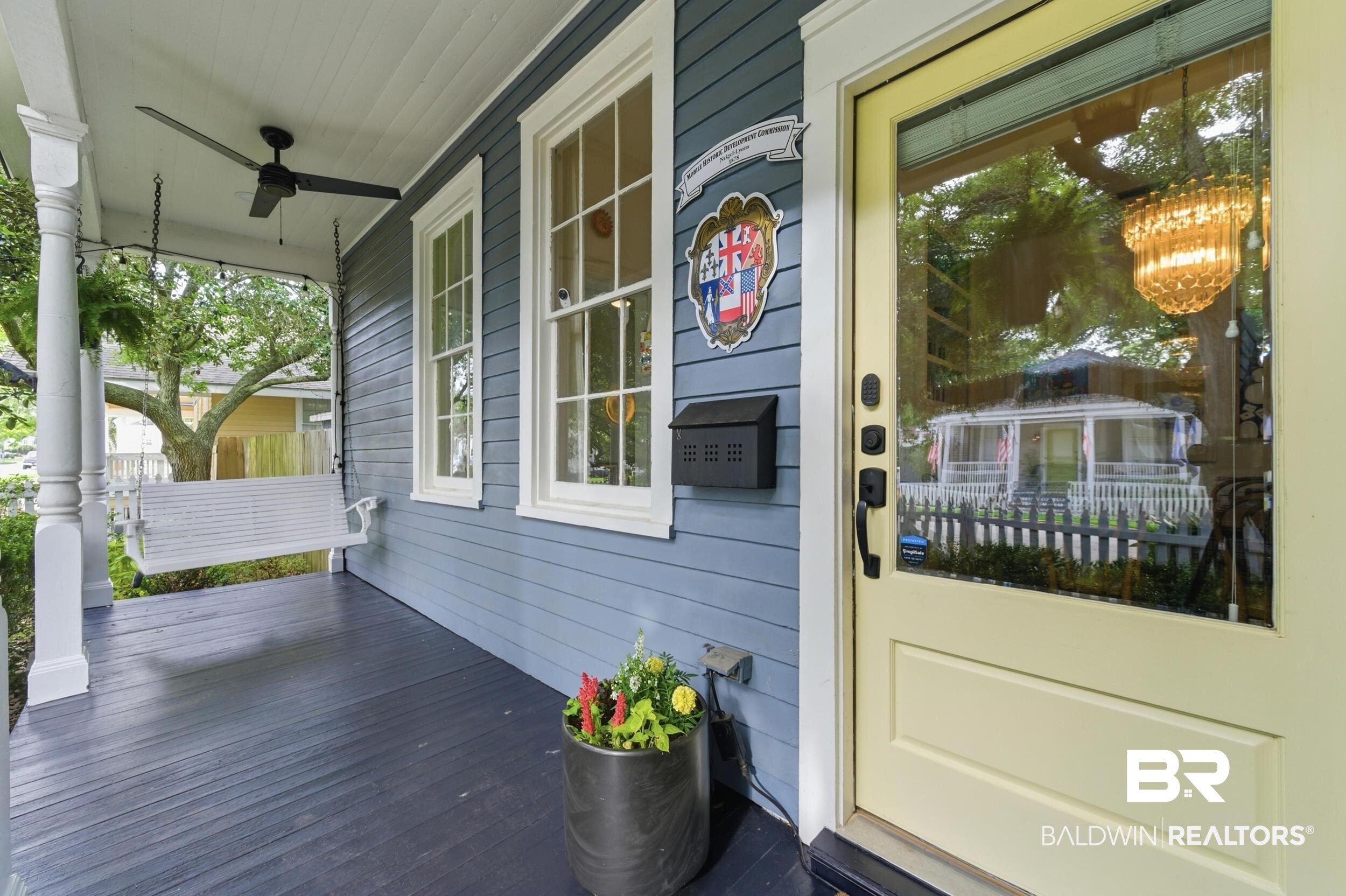 350 Charles Street Mobile, AL 36604 - Photo 39 of 52 Inviting front porch featuring a porch swing, ceiling fan, and painted wood flooring