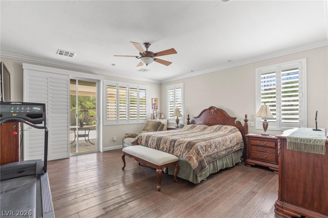 8431 Durango Ranch Court Las Vegas, NV 89113 - Photo 25 of 49 This spacious bedroom features wood flooring, offering comfort and direct outdoor access.