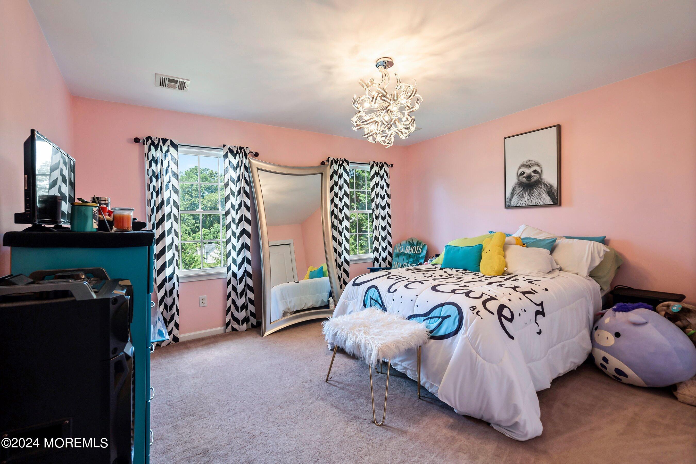 5 Summers Drive Jackson, NJ 08527 - Photo 28 of 40 a bedroom with a bed and a chandelier