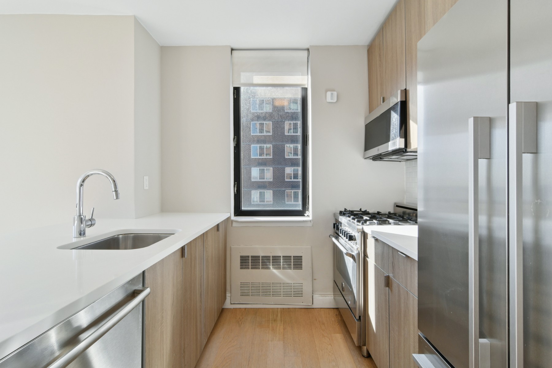 345 East 94th Street, Unit 21C Manhattan, NY 10128 - Photo 5 of 29 a kitchen with stainless steel appliances granite countertop a refrigerator and a sink