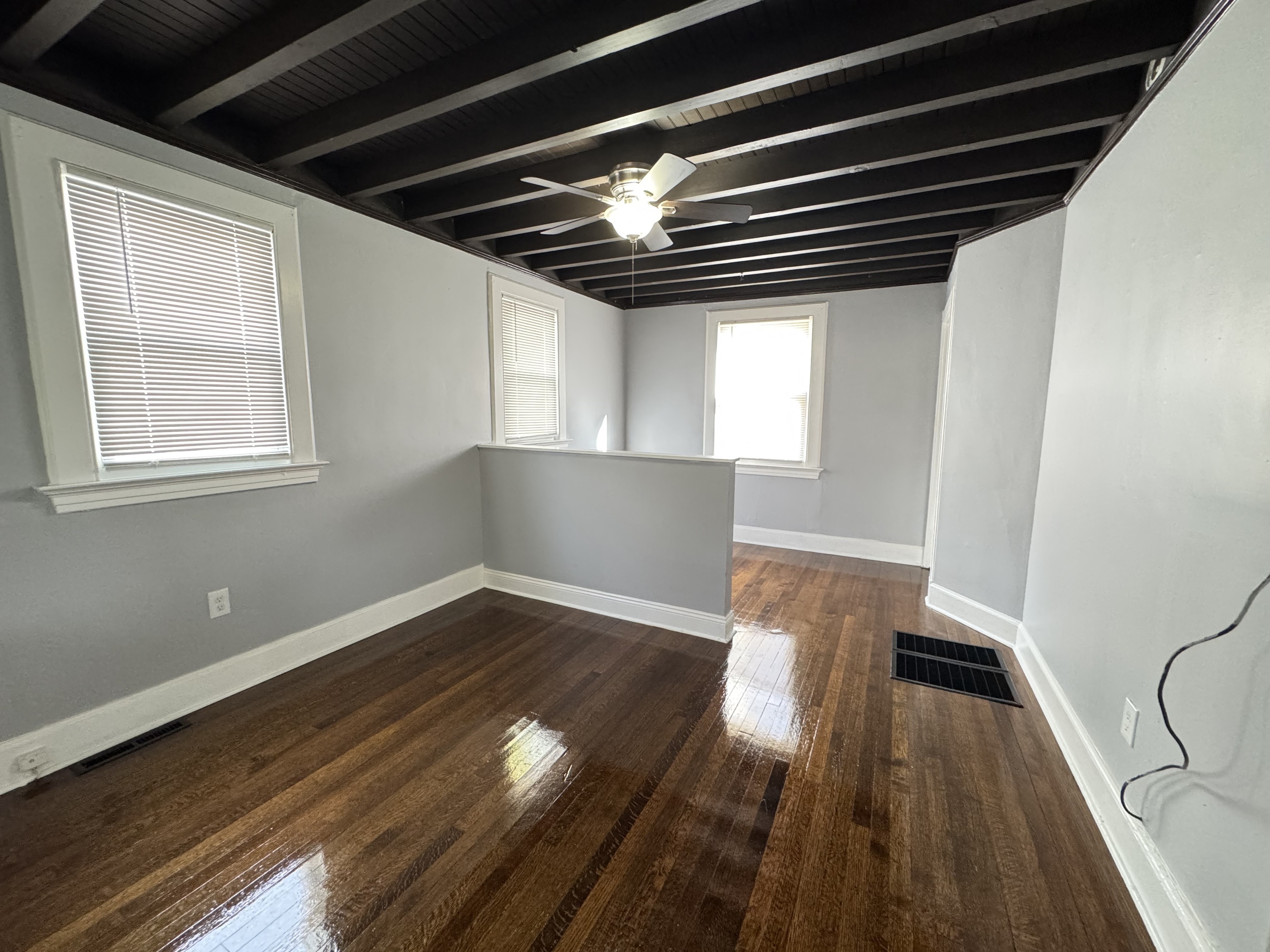 959 Winchester Avenue Hamden, CT 06517 - Photo 3 of 12 a view of an empty room with wooden floor and a window