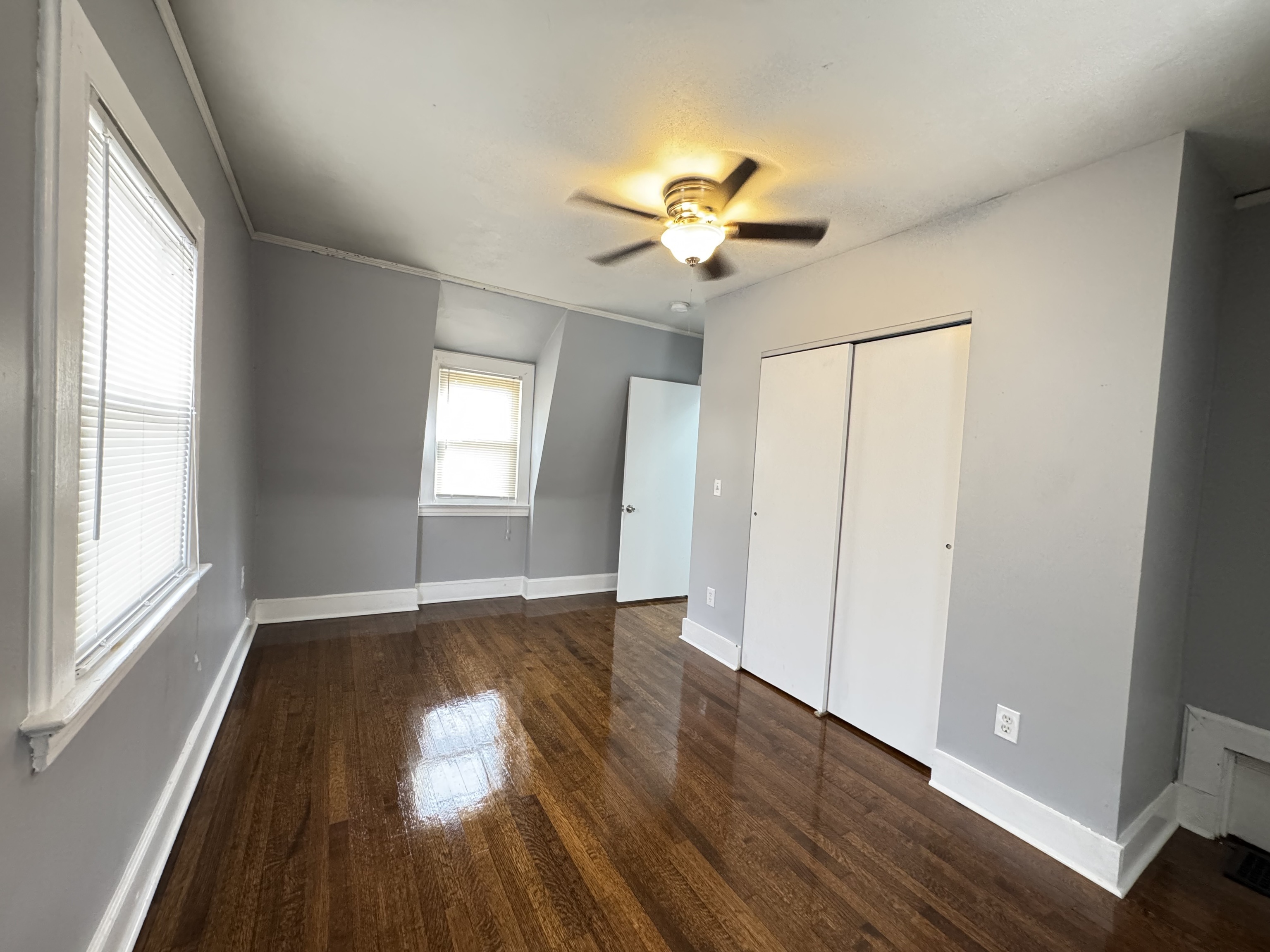 959 Winchester Avenue Hamden, CT 06517 - Photo 9 of 12 an empty room with wooden floor fan and windows