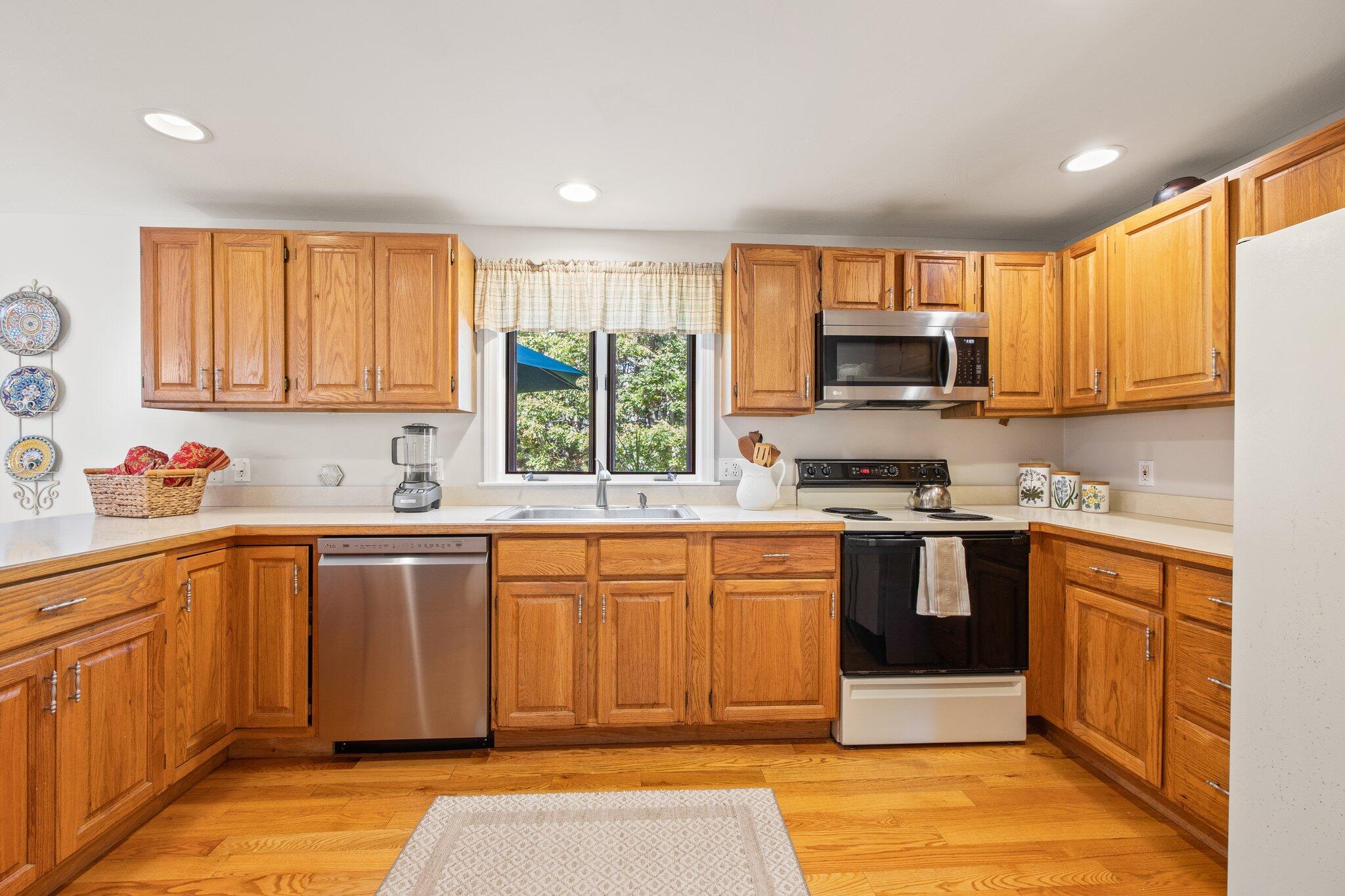 49 River Ridge Road Marstons Mills, MA 02648 - Photo 11 of 37 a large kitchen with stainless steel appliances granite countertop a stove a sink dishwasher and a microwave